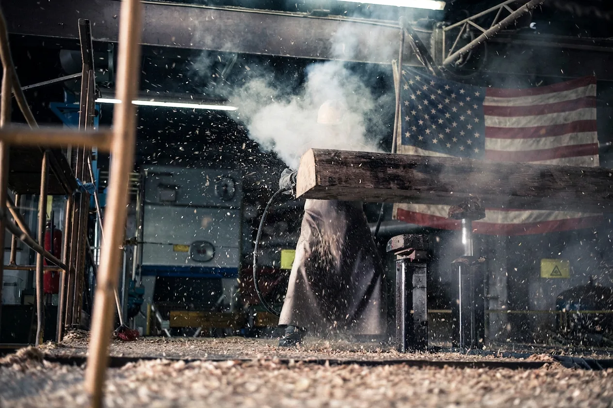 A billet under a forging hammer on a plant floor