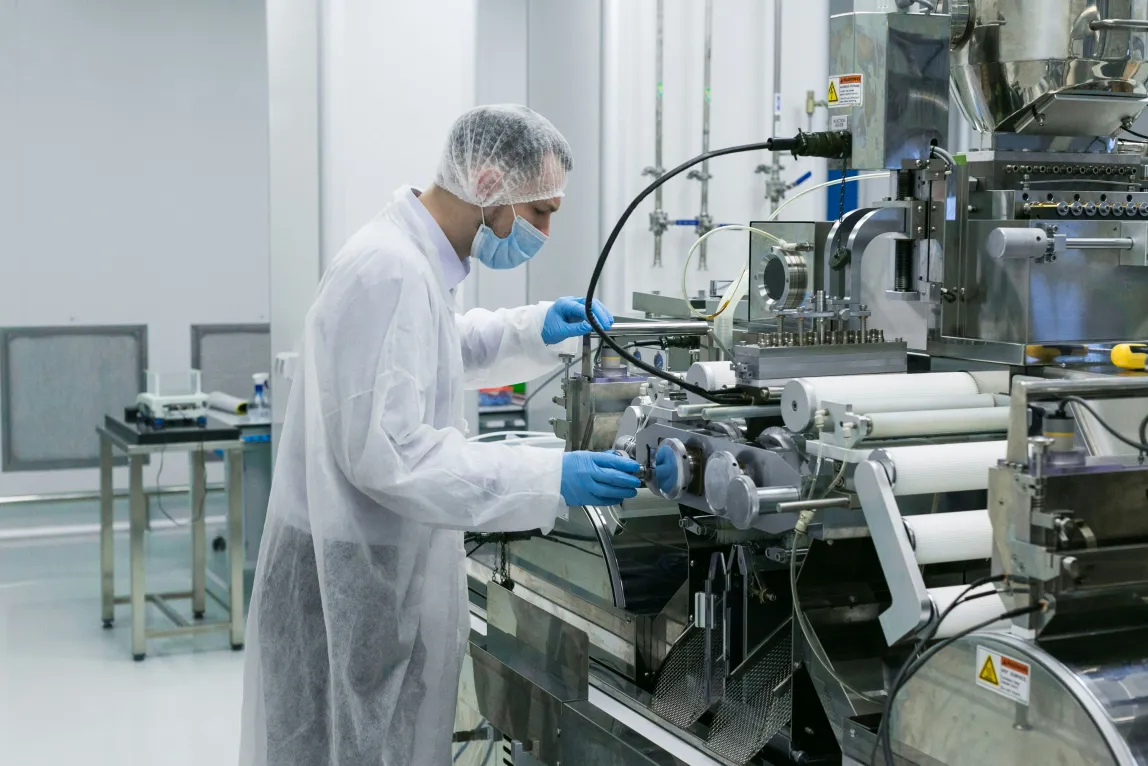 A technician assembling a precision component in a cleanroom
